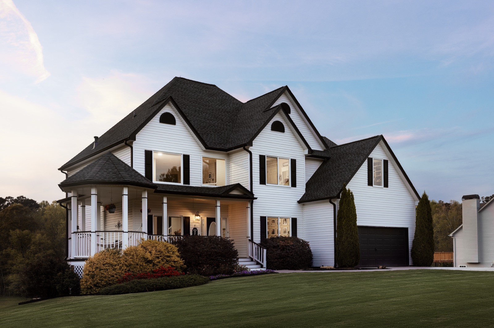 Home exterior at dusk with new replacement windows