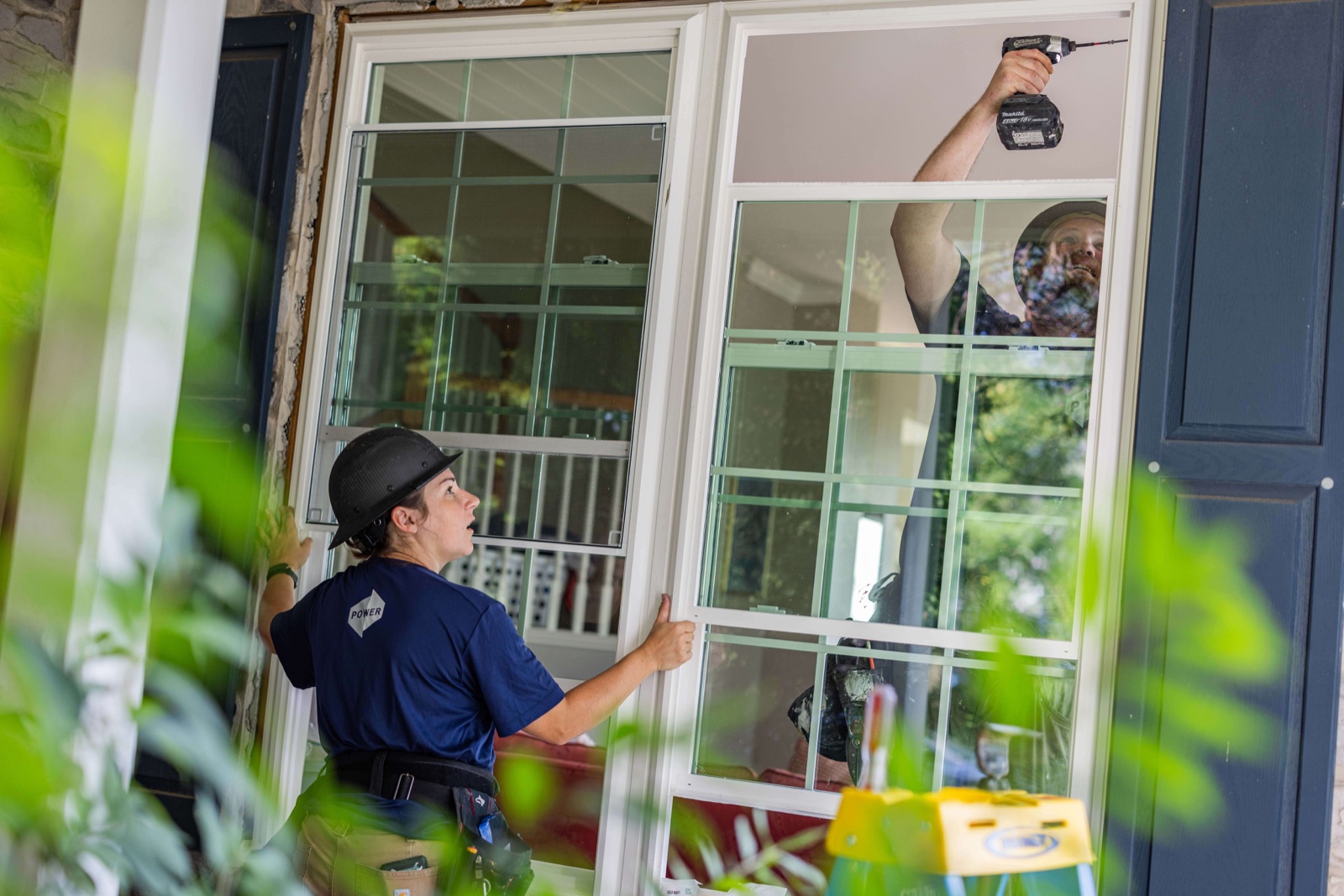 Power Home Remodeling technicians installing a new energy-efficient window